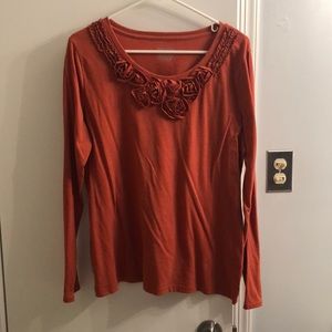 Orange top with rose embellishments
